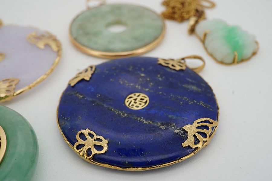 A collection of Chinese jewels, including three disc shaped pendants in pale lavender and green jadeite, mounted in gold, longest 4.6cm including bail; another disc-shaped pendant in lapis lazuli, mounted in gold; and a